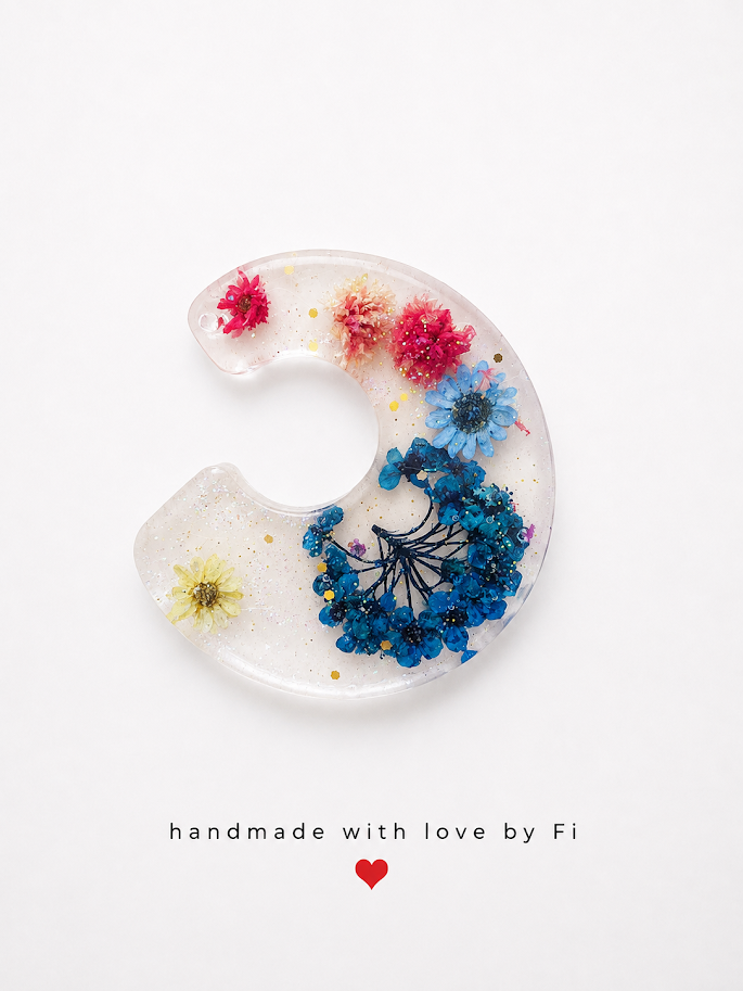 Multicolour dried flower resin crescent moon pendant with pink blue peach yellow flowers and gold glitter handmade by Fi