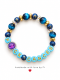 Bright blue F*CK CANCER letter bracelet with glossy blue and purple accents
