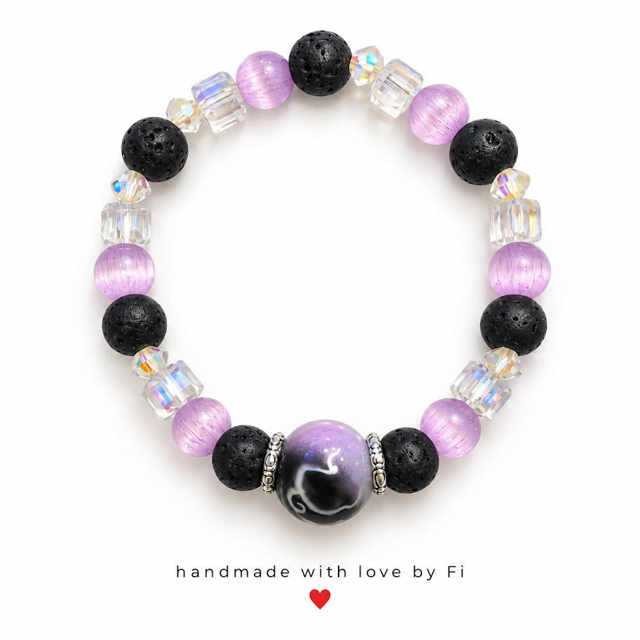 Handmade bracelet with textured black beads, lilac round beads, clear iridescent accents and a black and lilac swirl-effect centre bead