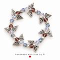 Silver-tone butterfly and star bracelet with clear iridescent and smoky purple faceted beads