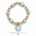Handmade bracelet with pastel blue and lavender faceted beads, iridescent accents and a large round shimmer-effect pendant