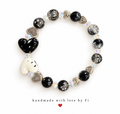Black and white heart bracelet with silver-flecked black beads, iridescent accents and silver-tone heart spacers
