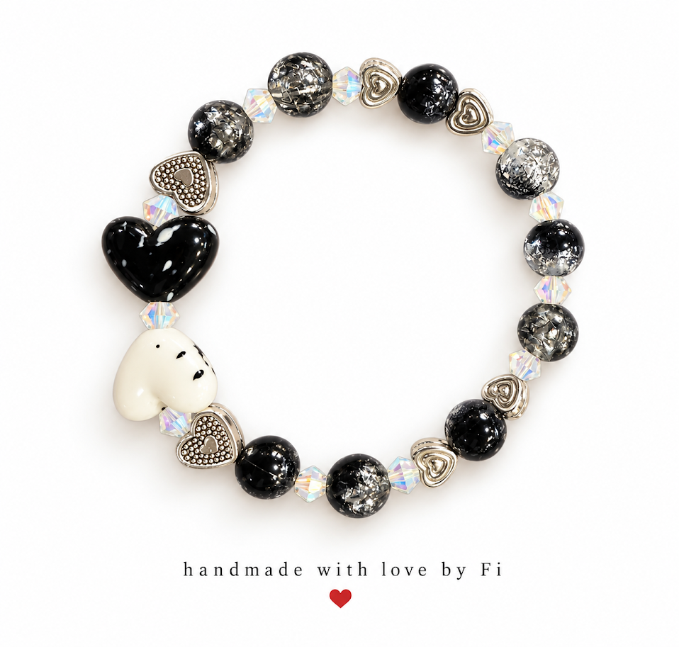 Black and white heart bracelet with silver-flecked black beads, iridescent accents and silver-tone heart spacers