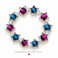 Blue and magenta beaded bracelet with silver-tone star frames and iridescent accents