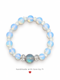 Handmade icy-blue opal-effect beaded bracelet with a glittering centre bead and clear accents