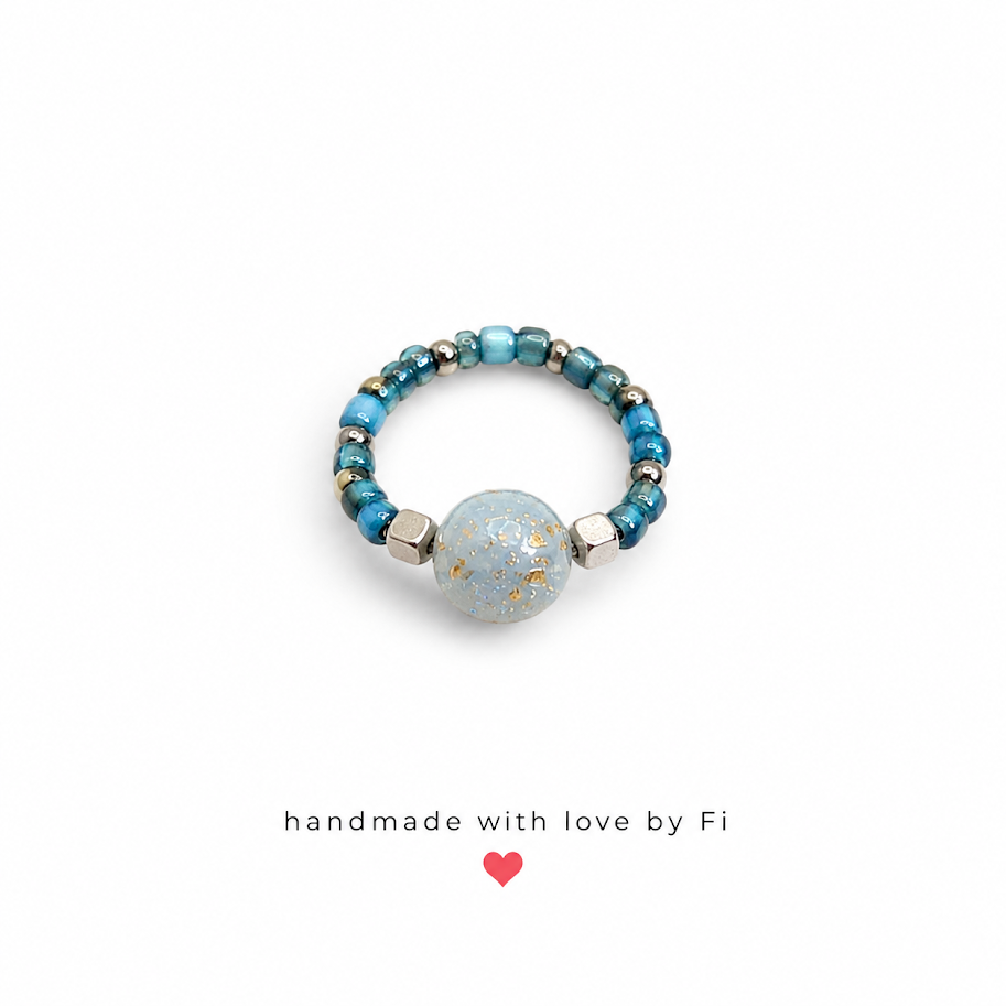 Teal and galaxy bead stretch ring handmade by Fi