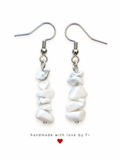 White chip-style drop earrings with subtle grey markings and silver-tone fishhook wires