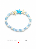 Pale blue and white cube bead bracelet with triple turquoise and cream ceramic starfish charm handmade by Fi