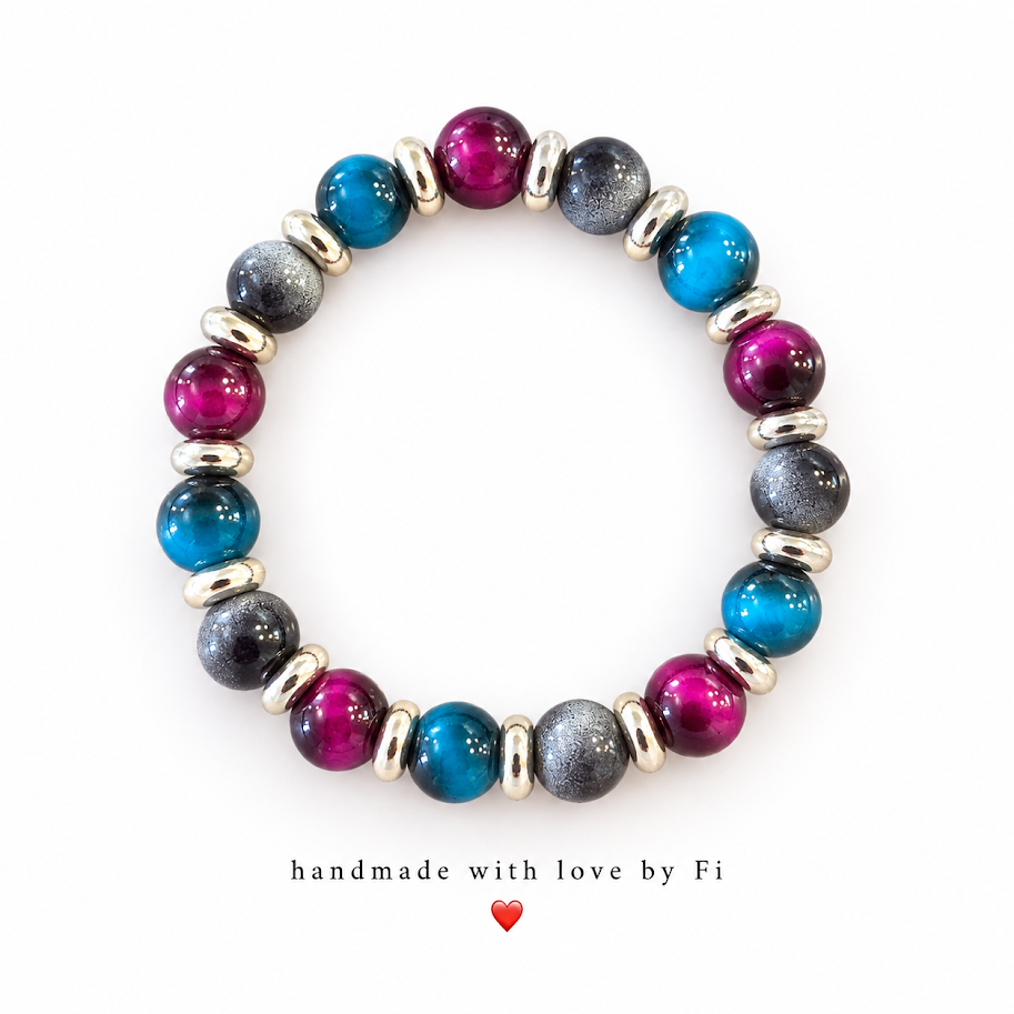 Glossy magenta and blue beads with textured charcoal-grey beads and silver-tone spacers