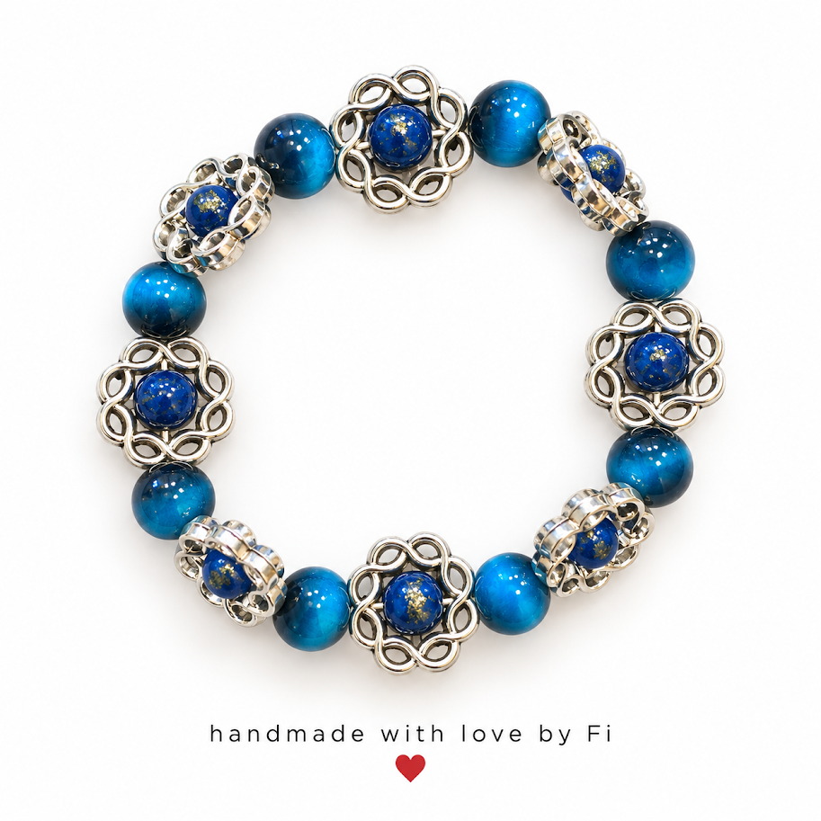 Deep blue beaded bracelet with silver-tone openwork swirl accents and gold-flecked blue beads